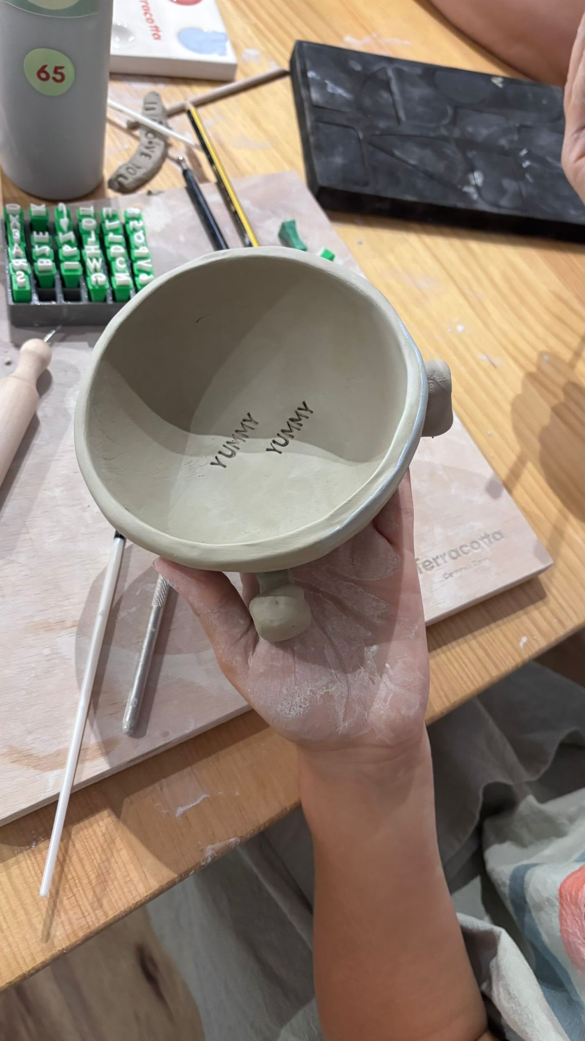 Hands shaping clay